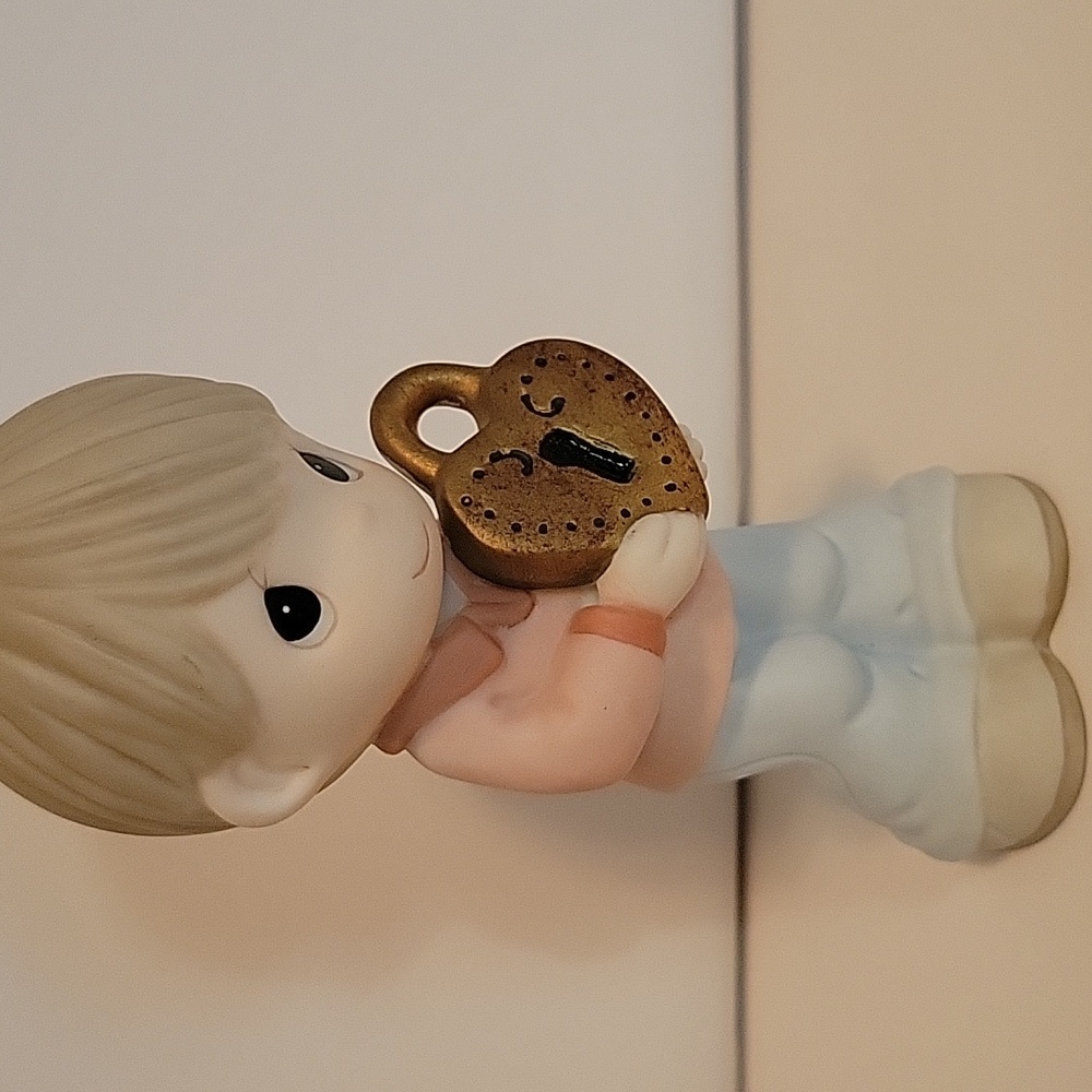 Precious Moments figurine, boy with lock.